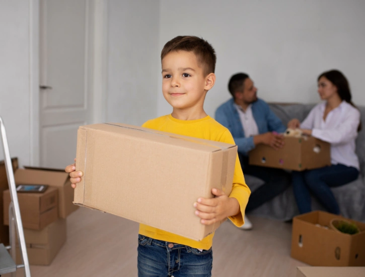 kid helping parents while moving in abu dhabi